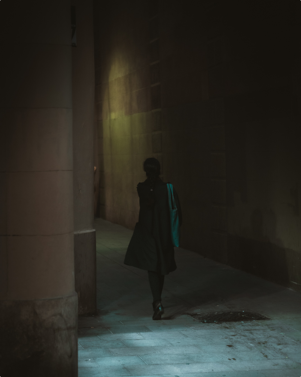 woman walking in an alley - photo by David Gallardo